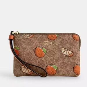 Last one! New Corner Zip Wristlet In Signature Canvas With Orange Print